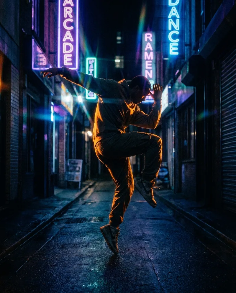A dancer mid-motion under colored stage lights — a short-form edit still